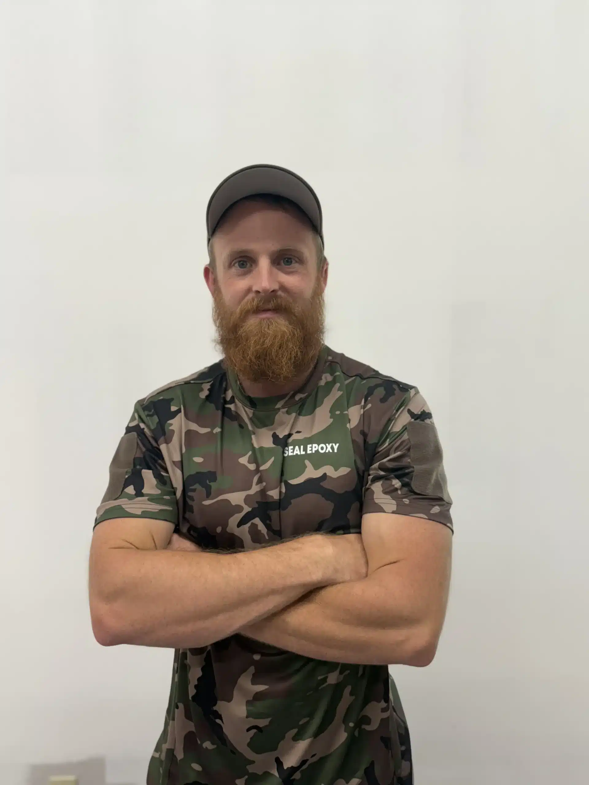 Seal Epoxy founder and owner wearing a branded shirt with arms crossed