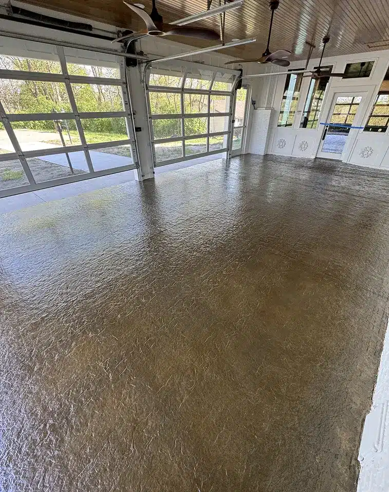 Brown epoxy garage floor with textured finish in a bright residential garage