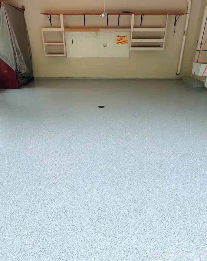Light gray epoxy flake garage floor in a finished residential garage