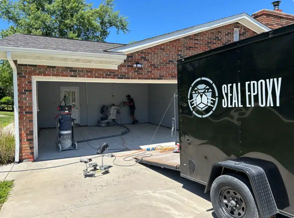 Seal Epoxy crew preparing a residential garage floor for epoxy coating installation