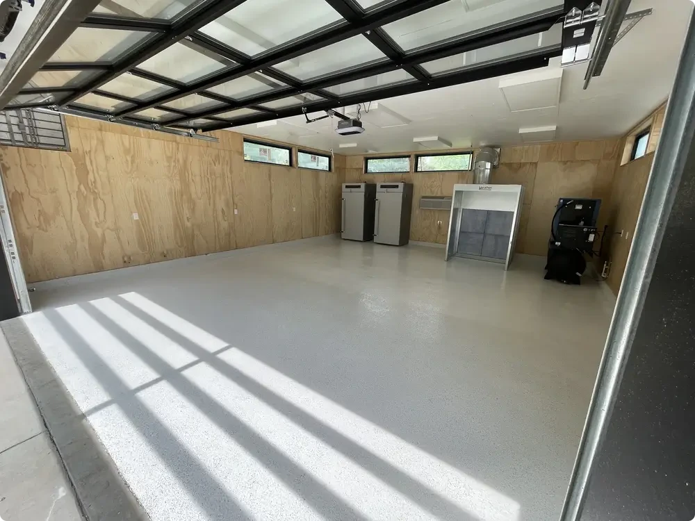 Light gray epoxy garage floor in a finished residential garage in Washington, Missouri