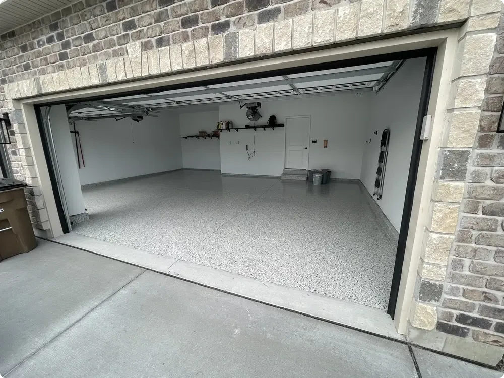 Gray epoxy flake garage floor in a two-car garage in Wildwood, Missouri