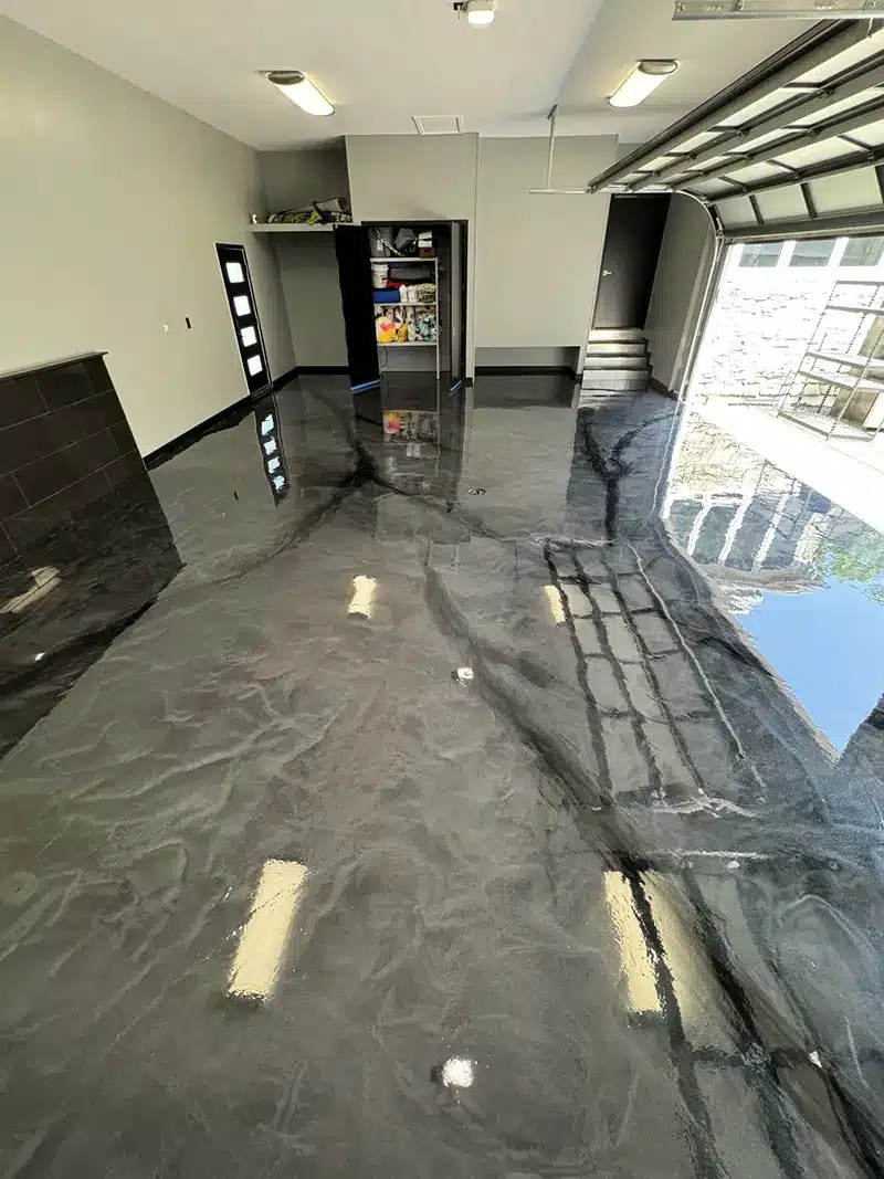 Glossy metallic gray epoxy garage floor with marbled finish