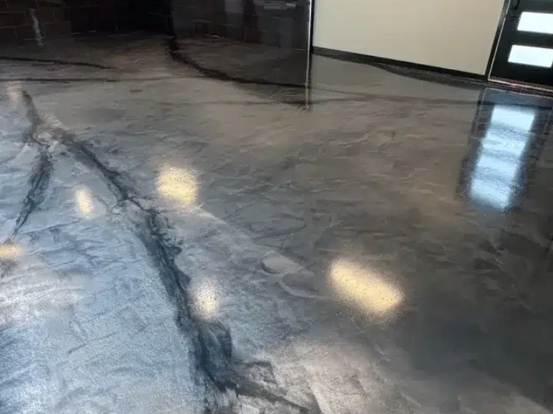 Metallic gray epoxy floor with black marble-style veining in a finished garage