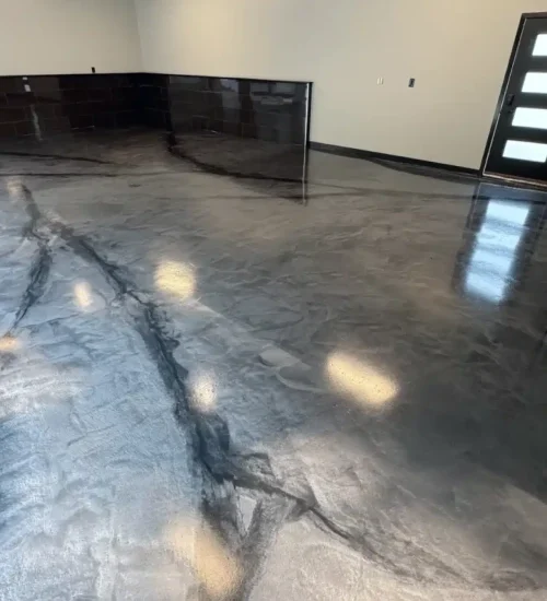 Metallic gray epoxy floor with black marble-style veining in a finished garage