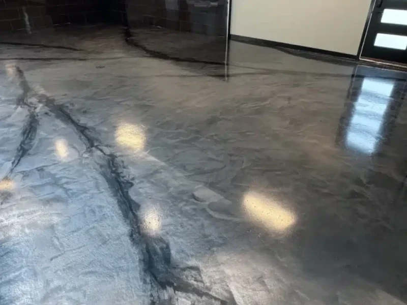Metallic gray epoxy floor with black marble-style veining in a finished garage