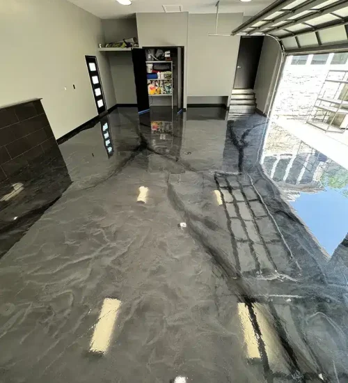 Glossy metallic gray epoxy garage floor with marbled finish
