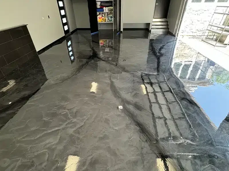 Glossy metallic gray epoxy garage floor with marbled finish