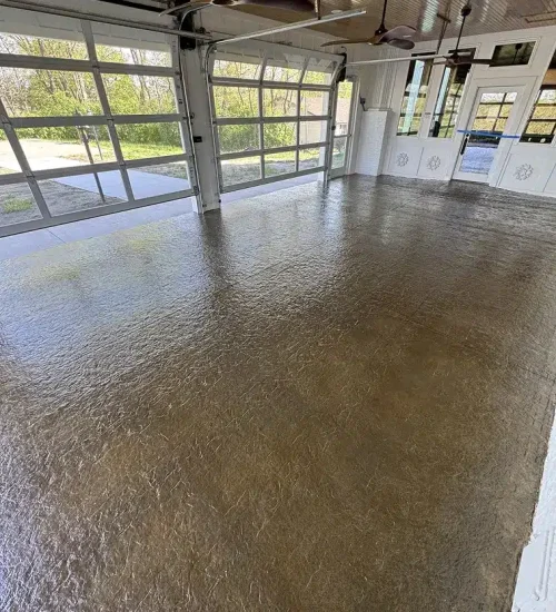 Brown epoxy garage floor with textured finish in a bright residential garage
