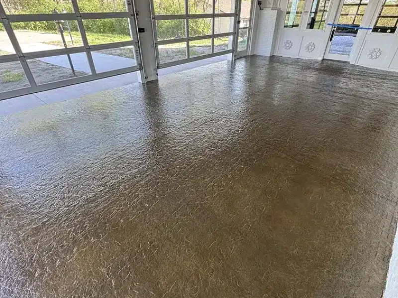 Brown epoxy garage floor with textured finish in a bright residential garage