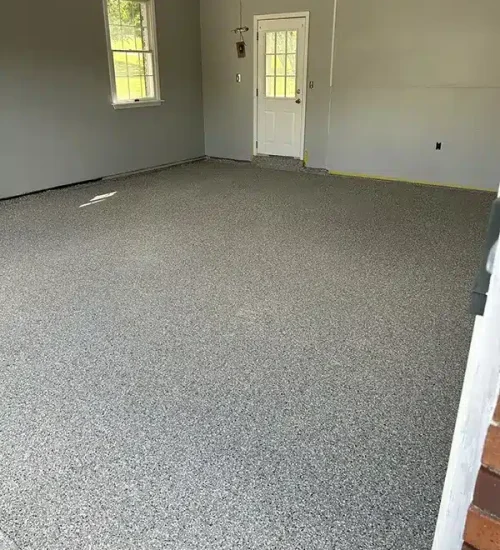 Gray epoxy garage floor with decorative flake finish in a residential garage