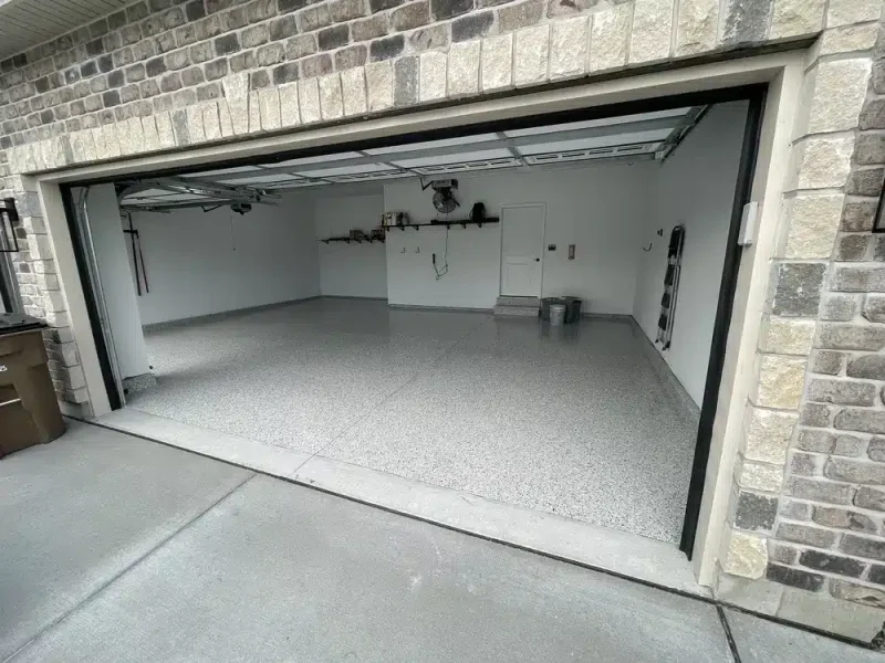 Light gray epoxy flake floor in a finished two-car residential garage