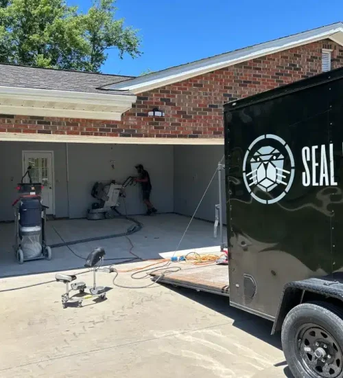 Seal Epoxy crew preparing a residential garage floor for epoxy coating installation