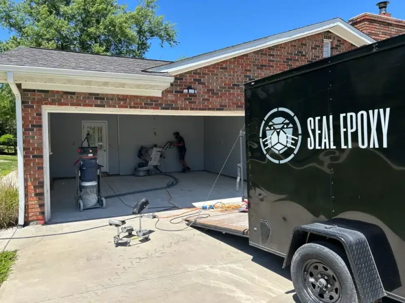 Seal Epoxy crew preparing a residential garage floor for epoxy coating installation